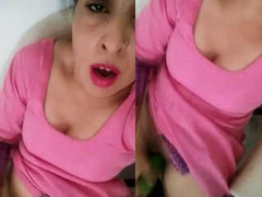 Horny Desi cougar wearing a pink dress while playing with one XXX cucumber