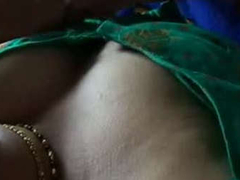 Desi wife is wearing a green blouse while getting her big natural boobs XXX